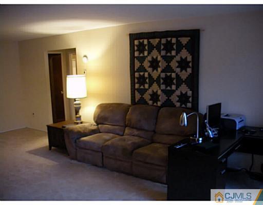 1618 Raspberry Court Edison, NJ 08817 - Photo 8 of 10 a living room with furniture a lamp and a window