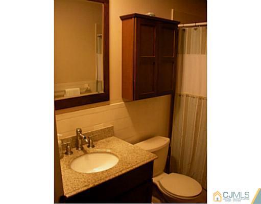 1618 Raspberry Court Edison, NJ 08817 - Photo 9 of 10 a bathroom with a granite countertop sink toilet and shower