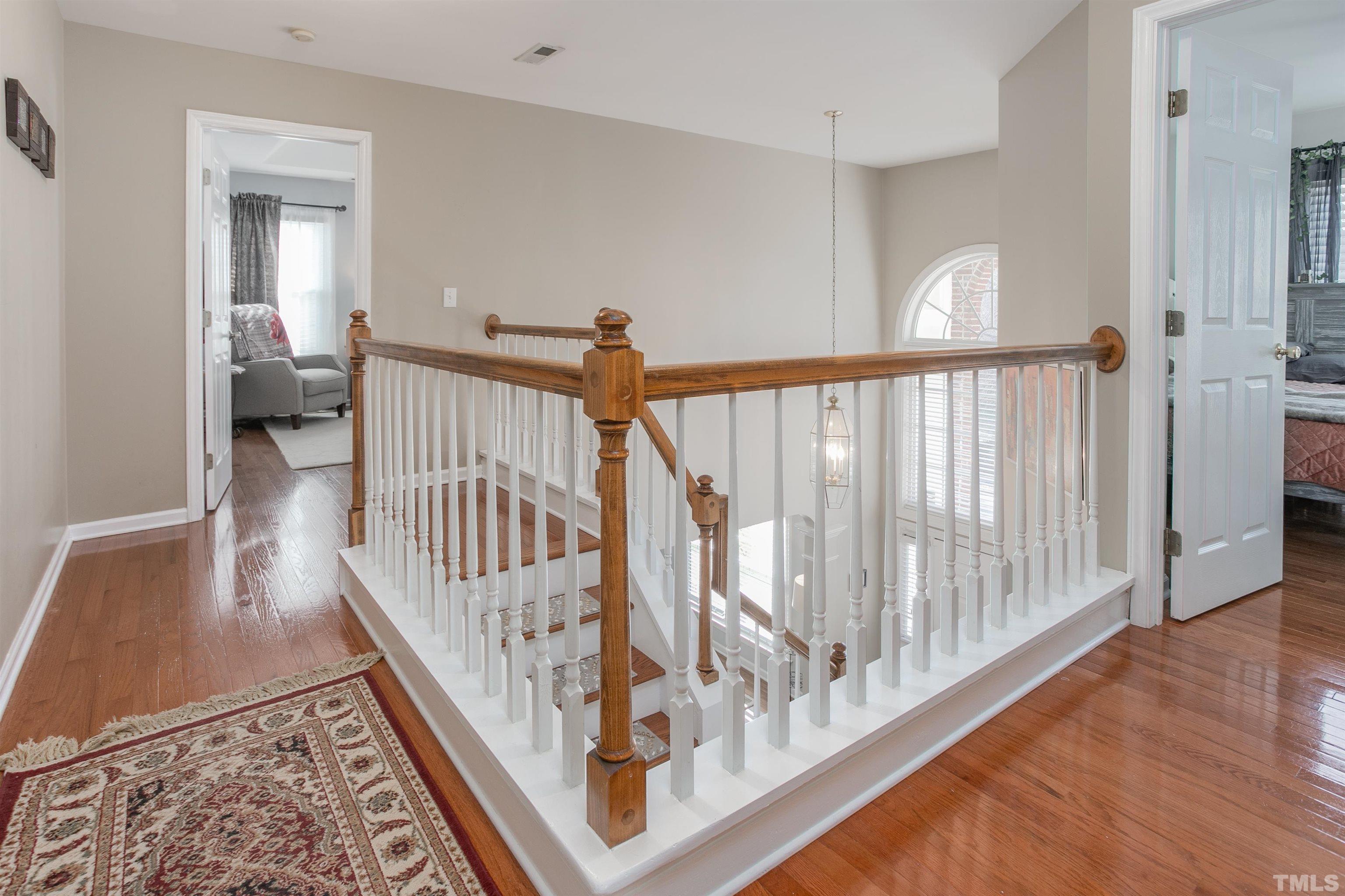 8832 Braceridge Road Raleigh, NC 27613 - Photo 23 of 40 a view of staircase with railing and a rug