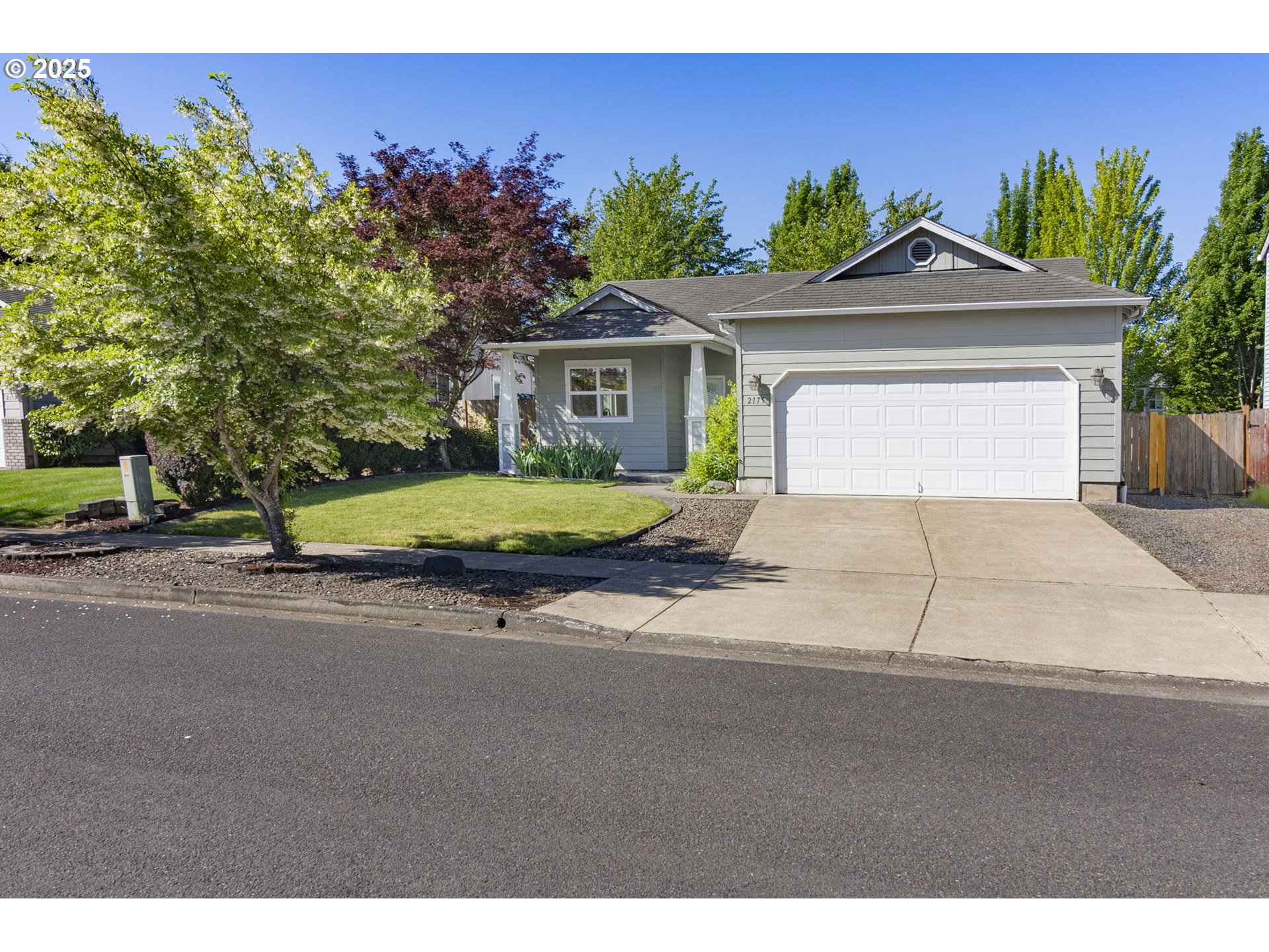 2175 Kelsey Lane Eugene, OR 97402 - Photo 1 of 27 a house with a yard and a car park in front of it