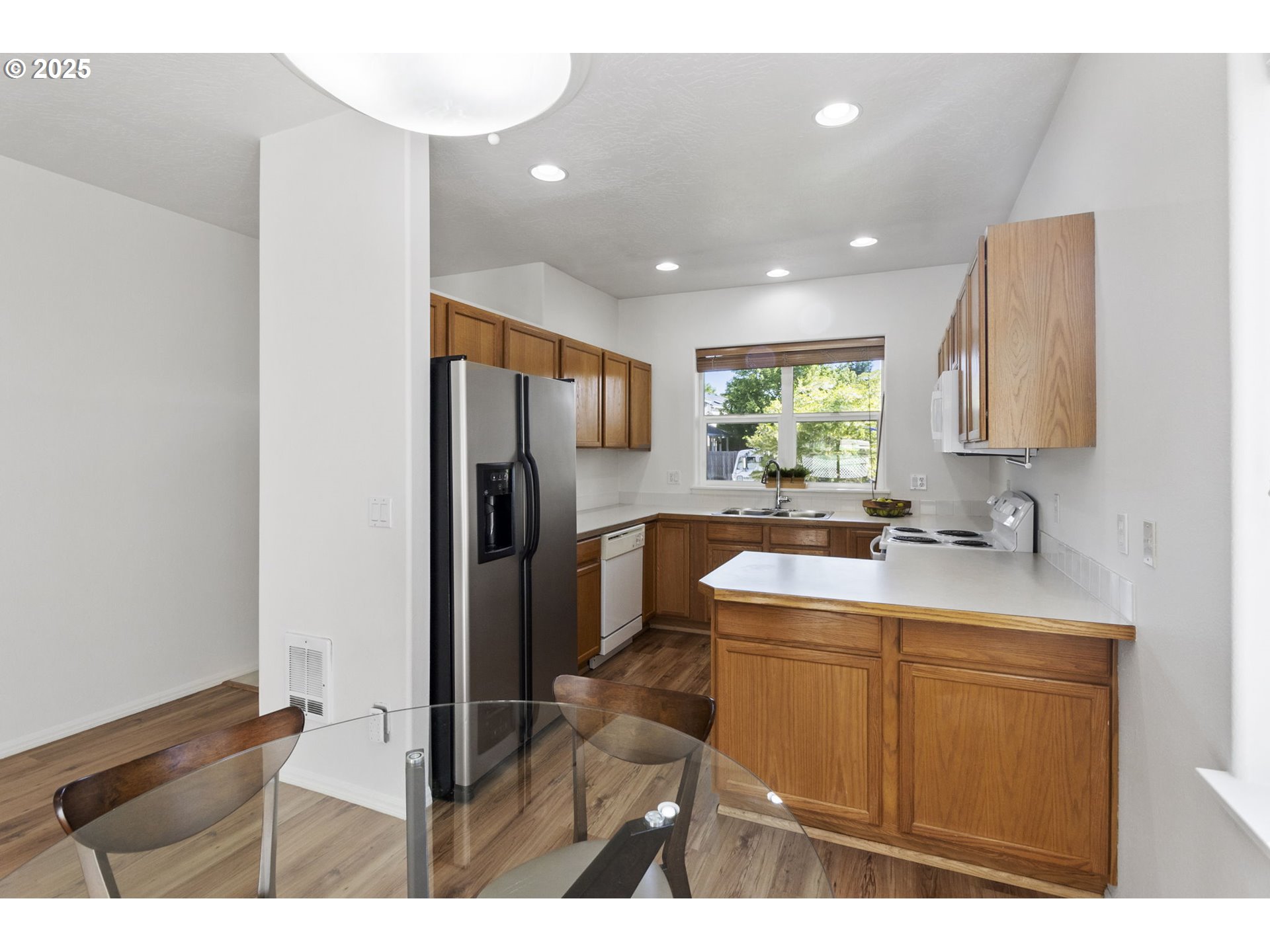 2175 Kelsey Lane Eugene, OR 97402 - Photo 8 of 27 a kitchen with kitchen island a sink appliances and cabinets