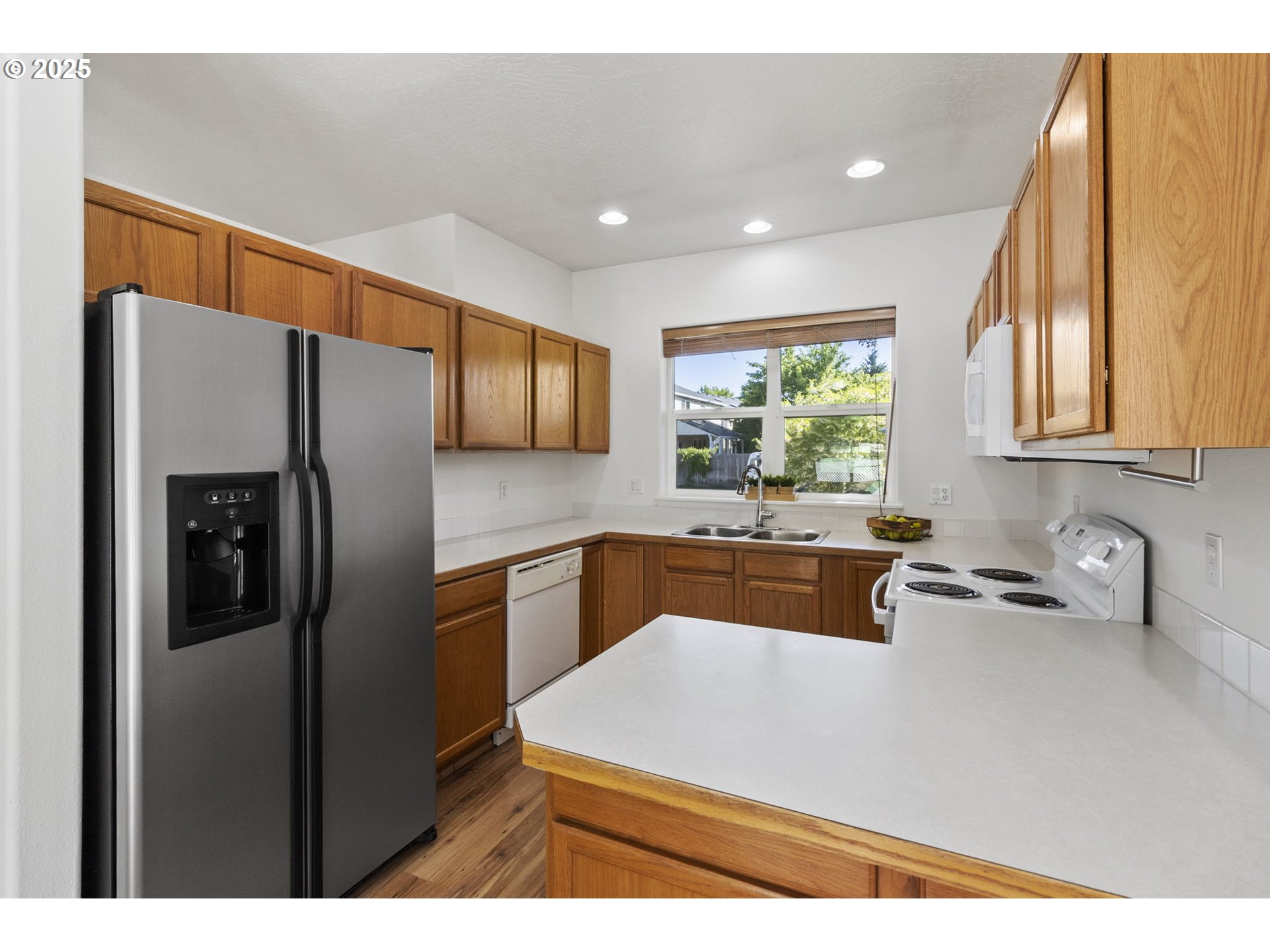 2175 Kelsey Lane Eugene, OR 97402 - Photo 9 of 27 a kitchen with stainless steel appliances a refrigerator sink and cabinets