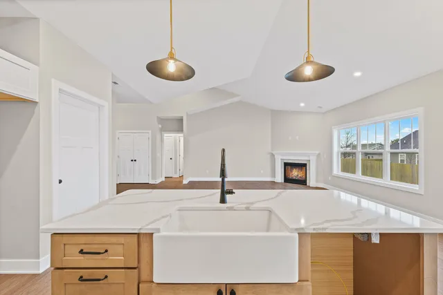 a large white kitchen with a sink a refrigerator and a stove
