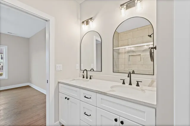 an empty room with a window and ceiling fan