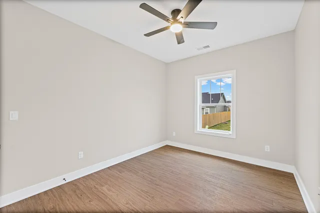 a view of an empty room and wooden floor