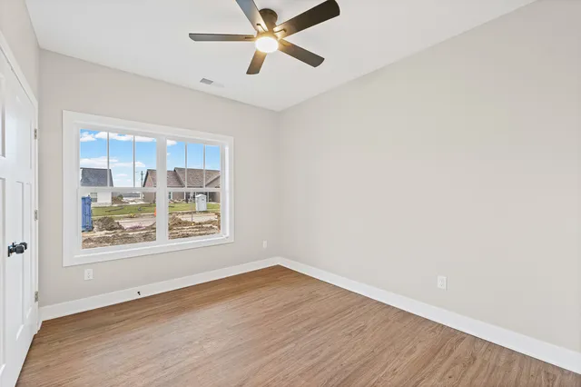 a view of an empty room and wooden floor