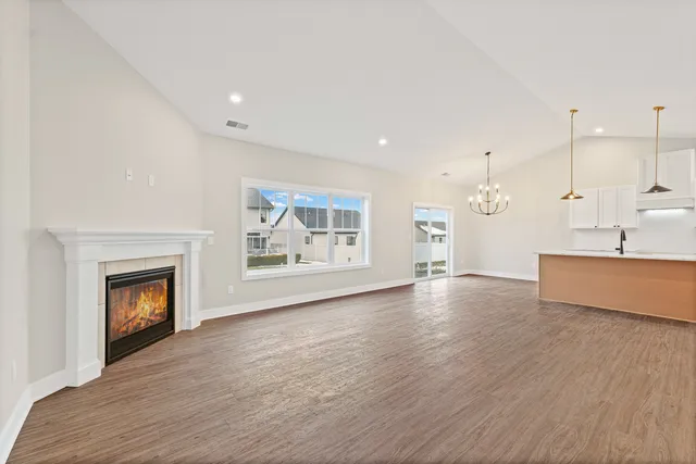 a view of an empty room with a fireplace and a window
