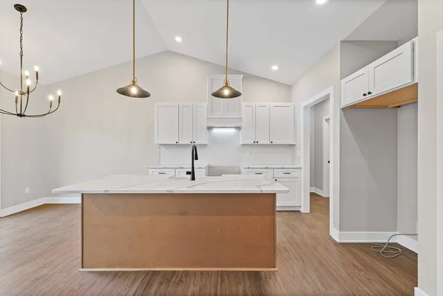 a very nice looking kitchen with center island stainless steel appliances and wooden floor