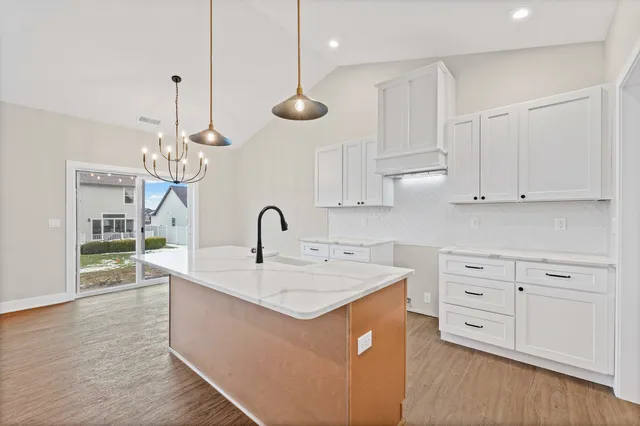 a kitchen with a sink and a chandelier