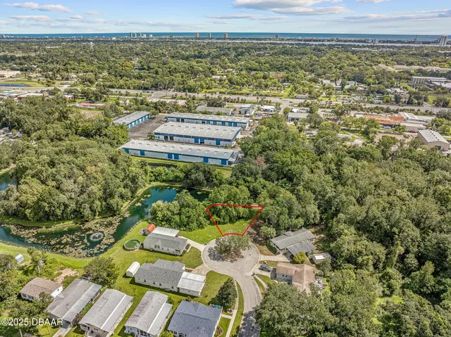 an aerial view of residential house with outdoor space and trees