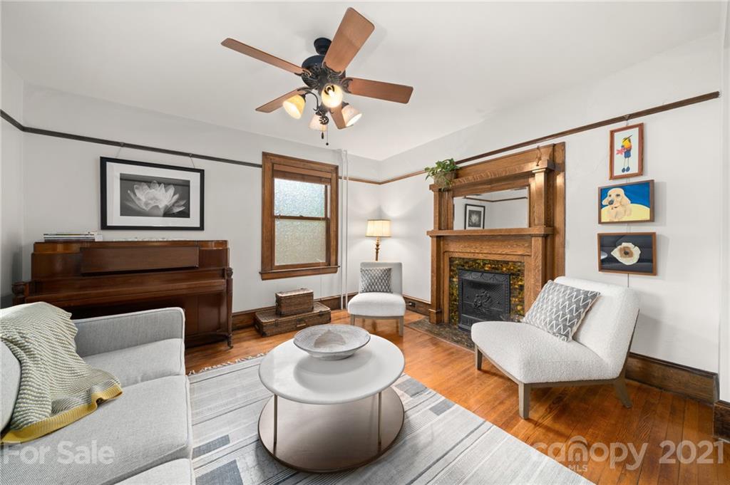 56 Pearson Drive Asheville, NC 28801 - Photo 11 of 44 a living room with furniture a fireplace and a flat screen tv