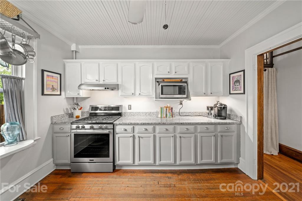 56 Pearson Drive Asheville, NC 28801 - Photo 12 of 44 a kitchen with stainless steel appliances granite countertop a stove a sink and a refrigerator