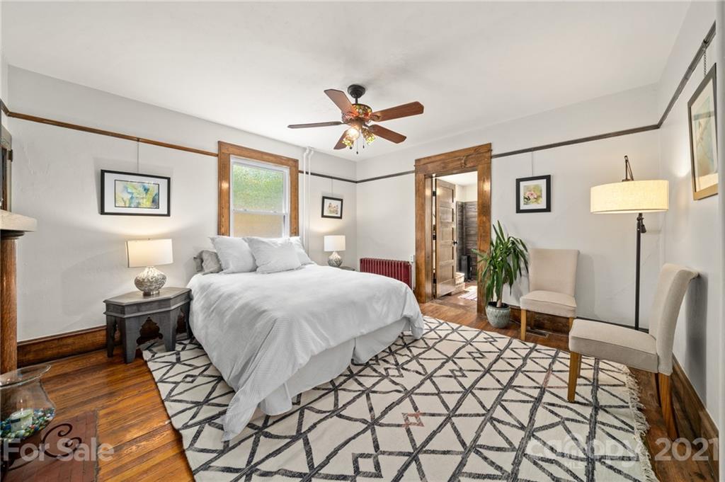 56 Pearson Drive Asheville, NC 28801 - Photo 15 of 44 a bedroom with a bed a lamp and potted plant
