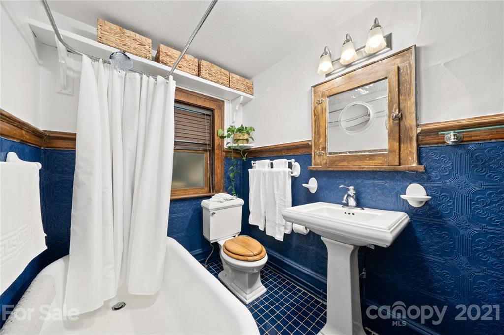 56 Pearson Drive Asheville, NC 28801 - Photo 23 of 44 a bathroom with a sink mirror and toilet