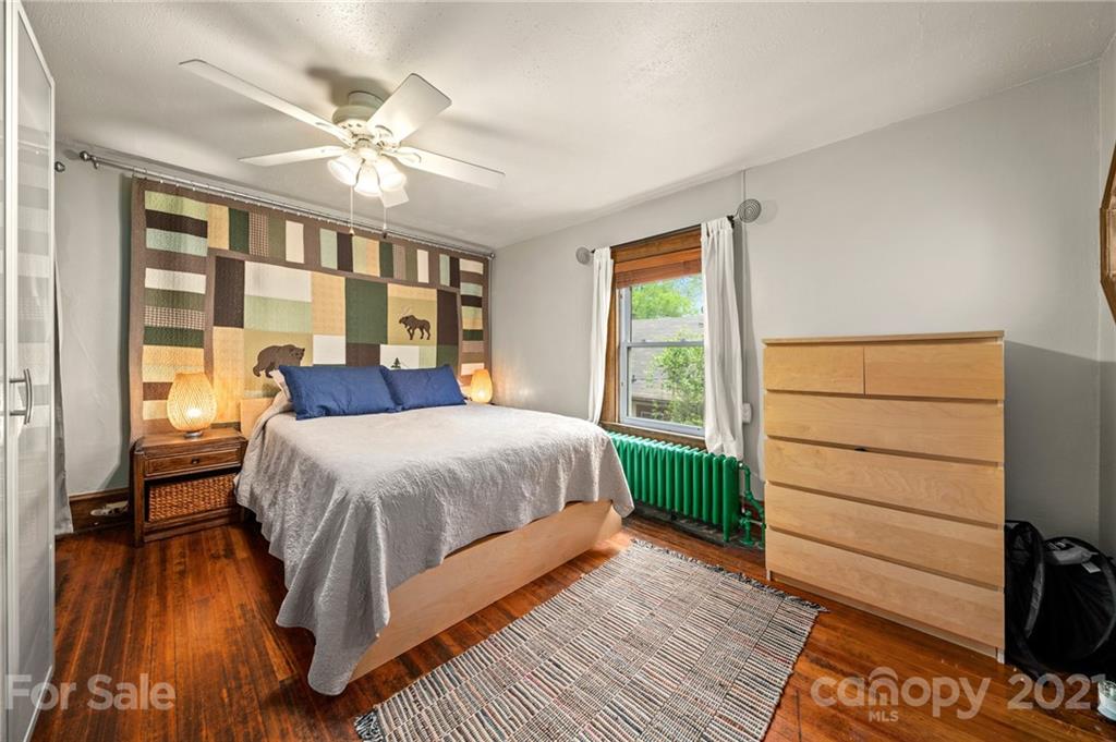 56 Pearson Drive Asheville, NC 28801 - Photo 24 of 44 a spacious bedroom with a bed and a dresser