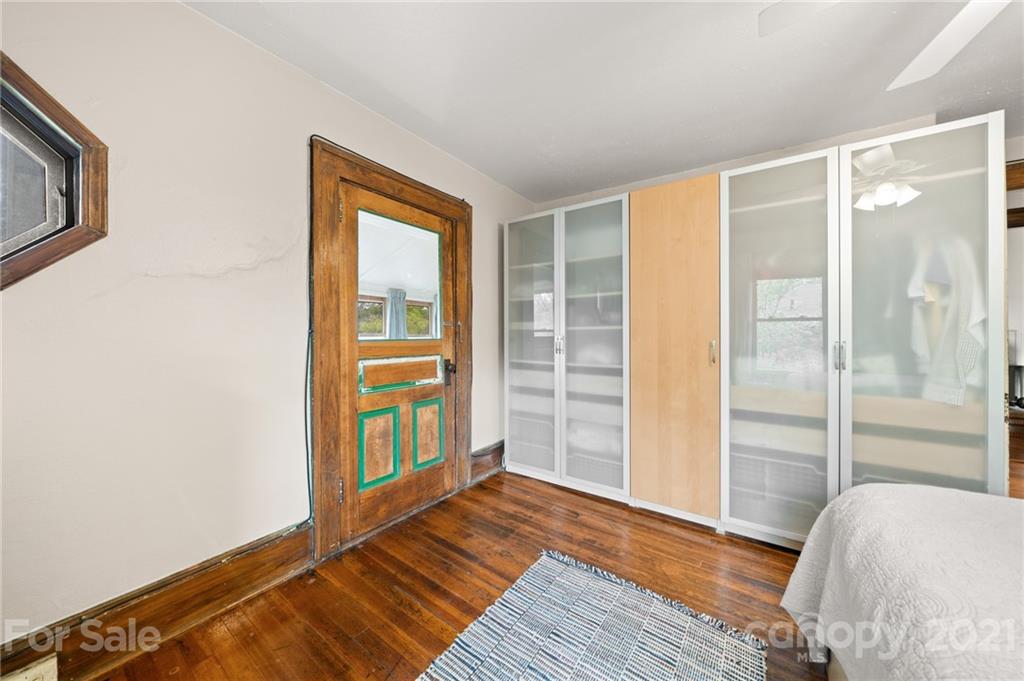 56 Pearson Drive Asheville, NC 28801 - Photo 25 of 44 a bedroom with a bed and wooden floor