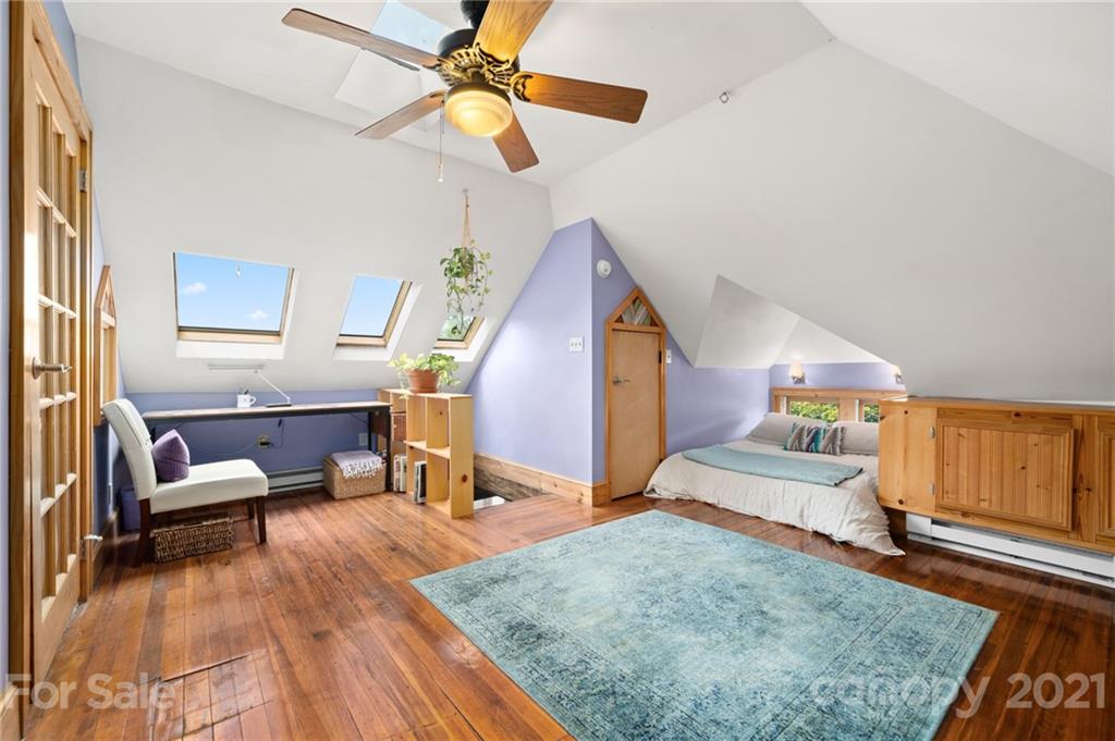 56 Pearson Drive Asheville, NC 28801 - Photo 31 of 44 a living room with furniture and a wooden floor