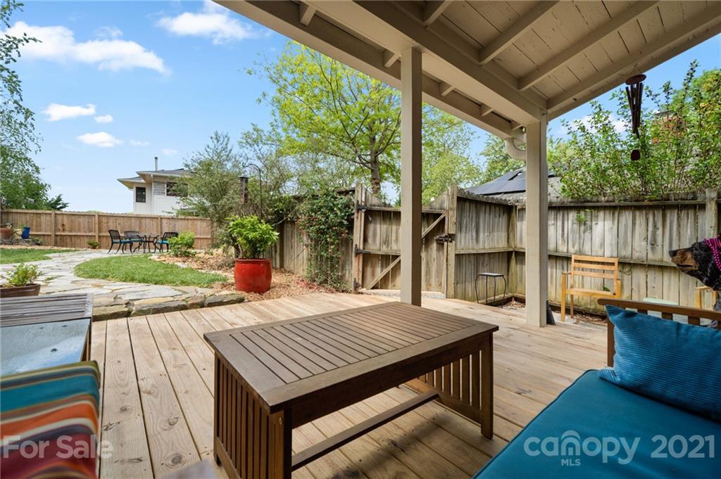 56 Pearson Drive Asheville, NC 28801 - Photo 35 of 44 a view of a patio with table and chairs potted plants with wooden floor and fence