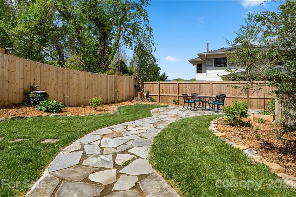 56 Pearson Drive Asheville, NC 28801 - Photo 36 of 44 a view of a backyard with a garden and plants