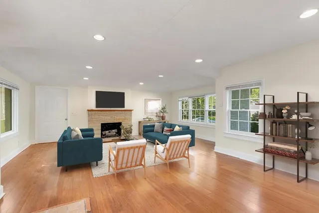 a living room with fireplace furniture and a wooden floor