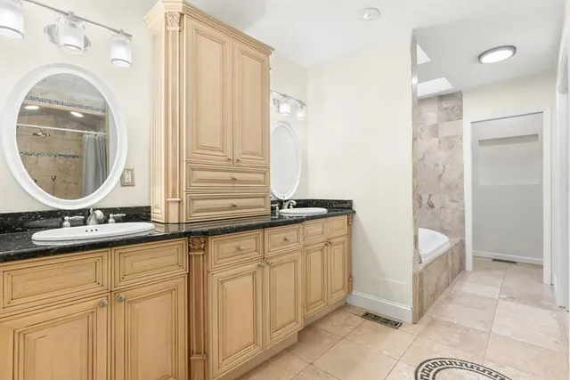 a bathroom with a double vanity sink and a mirror