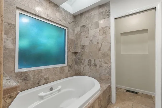 a bathroom with a tub and shower