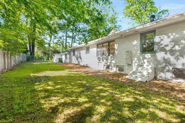 a backyard of a house with table and chairs