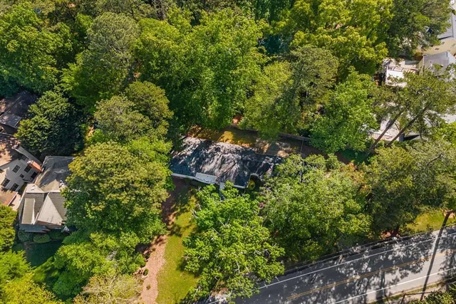a backyard of a house with lots of green space and garden