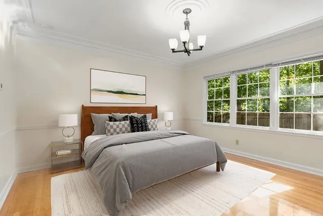 a bedroom with a large bed and a window