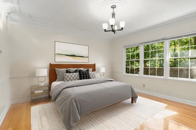 a bedroom with a large bed and a window