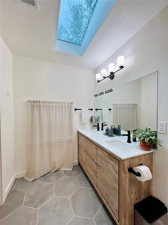 310 West 15th Street Irving, TX 75060 - Photo 14 of 30 a bathroom with a double vanity sink mirror and