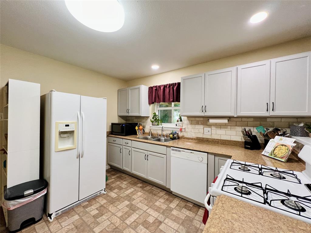 310 West 15th Street Irving, TX 75060 - Photo 19 of 30 a kitchen with stainless steel appliances granite countertop a refrigerator sink and stove