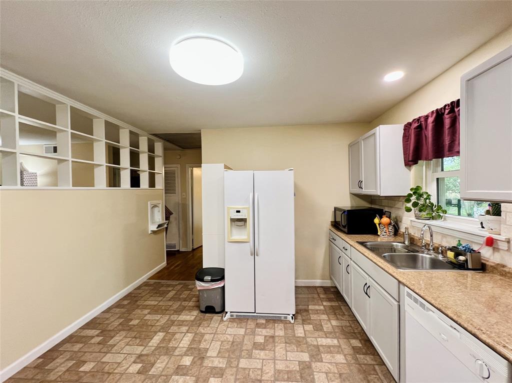 310 West 15th Street Irving, TX 75060 - Photo 20 of 30 a kitchen with a refrigerator and a sink