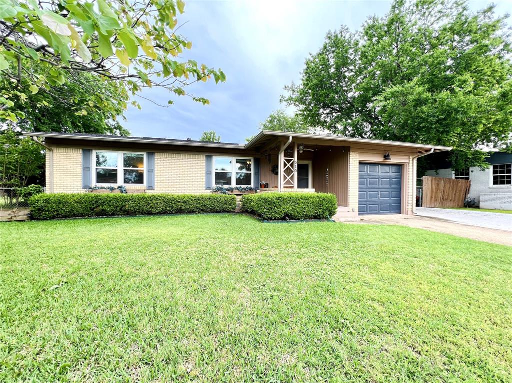 310 West 15th Street Irving, TX 75060 - Photo 2 of 30 a front view of house with yard and trees in the background