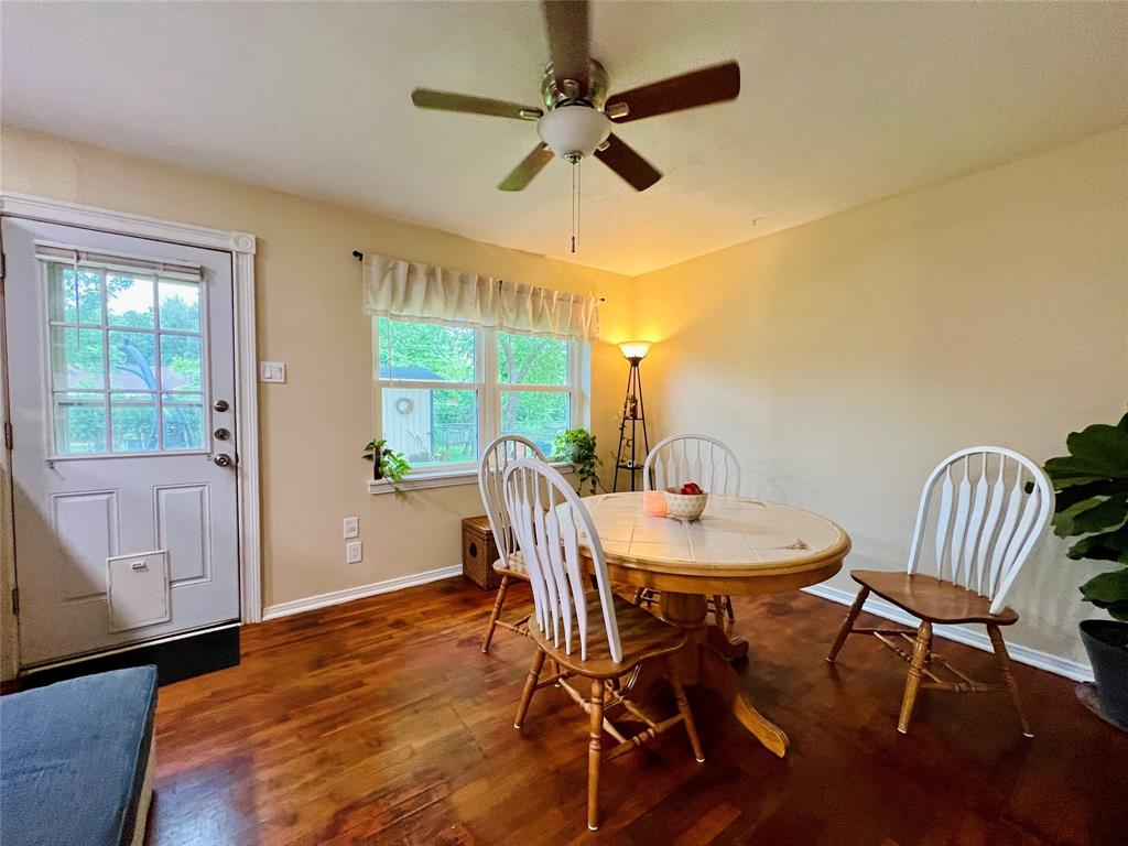 310 West 15th Street Irving, TX 75060 - Photo 24 of 30 a view of a dining room with furniture window and wooden floor