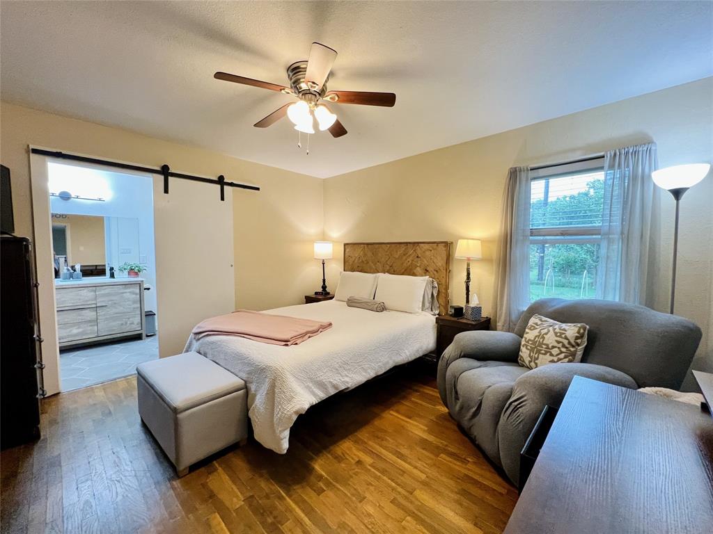 310 West 15th Street Irving, TX 75060 - Photo 7 of 30 a bedroom with a large bed and a couch