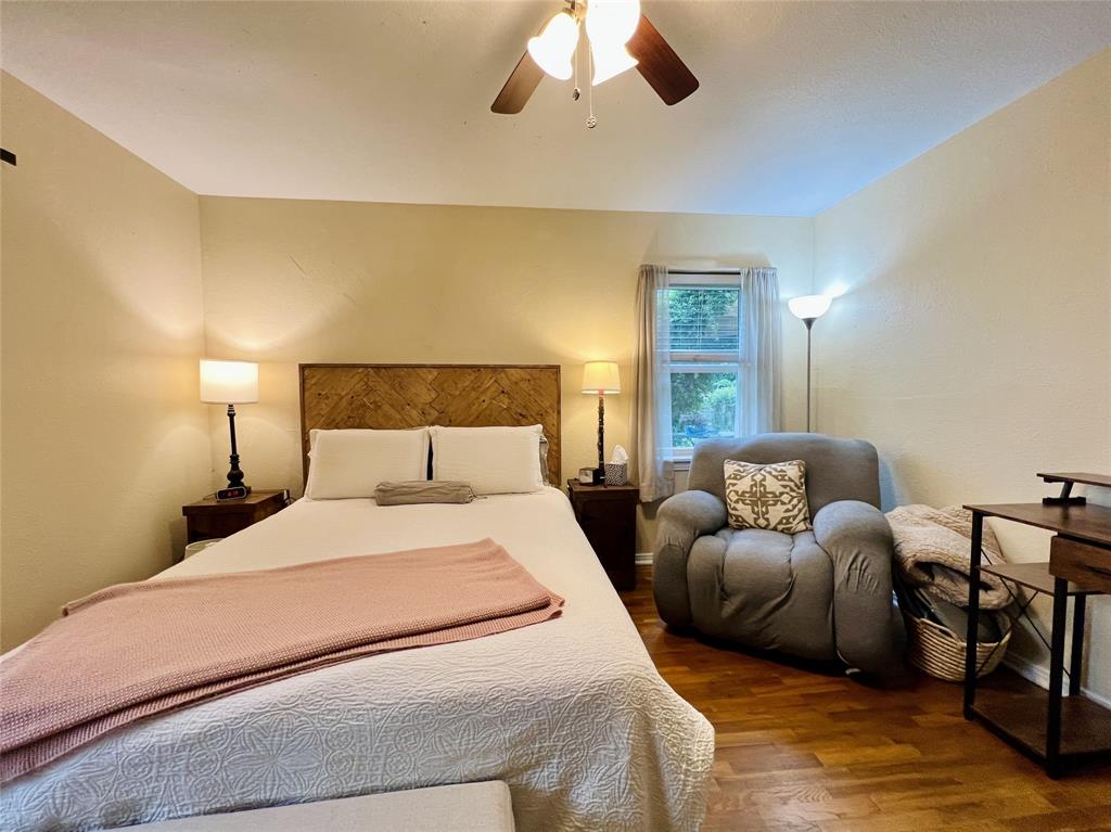 310 West 15th Street Irving, TX 75060 - Photo 9 of 30 a bedroom with bed and a chandelier