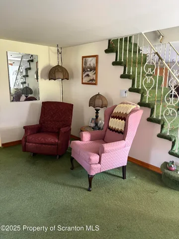 a living room with furniture and a rug