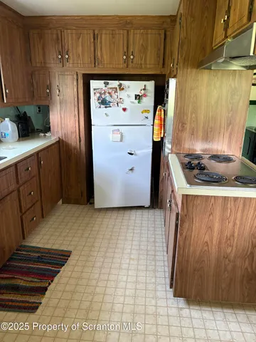 a kitchen with stainless steel appliances granite countertop a refrigerator and a stove