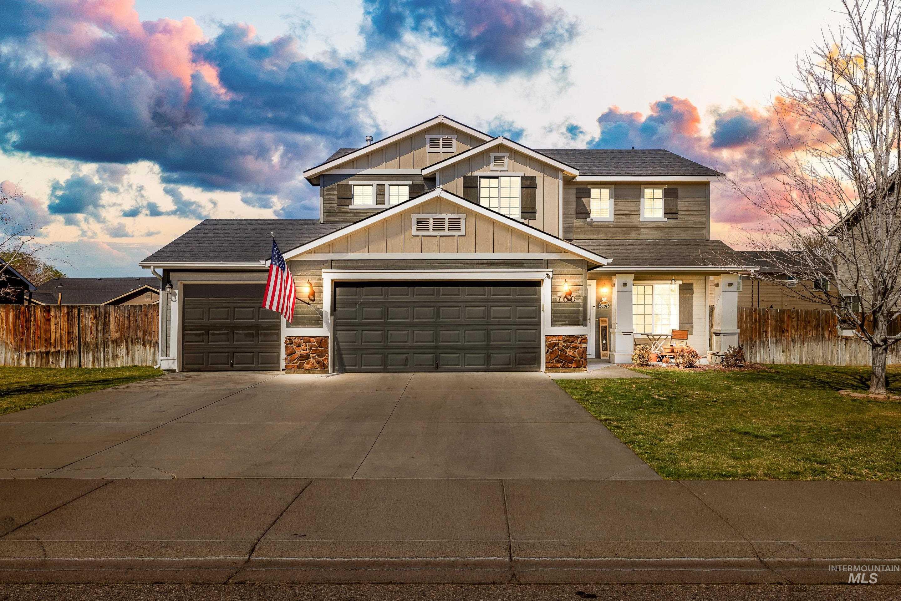 Craftsman-style house featuring board and batten siding, stone siding, concrete driveway, a garage, and a shingled roof