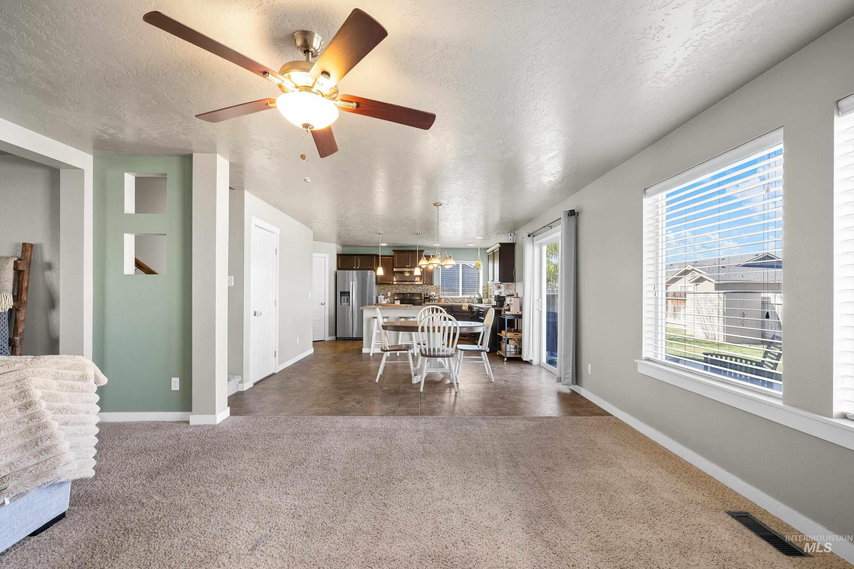 700 Southwest Panner Street Mountain Home, ID 83647 - Photo 11 of 50 Dining space with a textured ceiling and ceiling fan