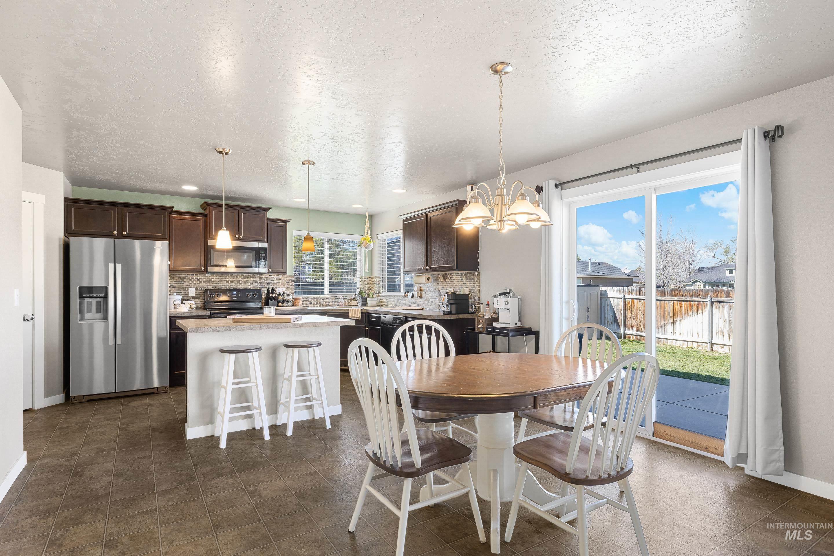 700 Southwest Panner Street Mountain Home, ID 83647 - Photo 12 of 50 Dining area with hanging lights and a textured ceiling