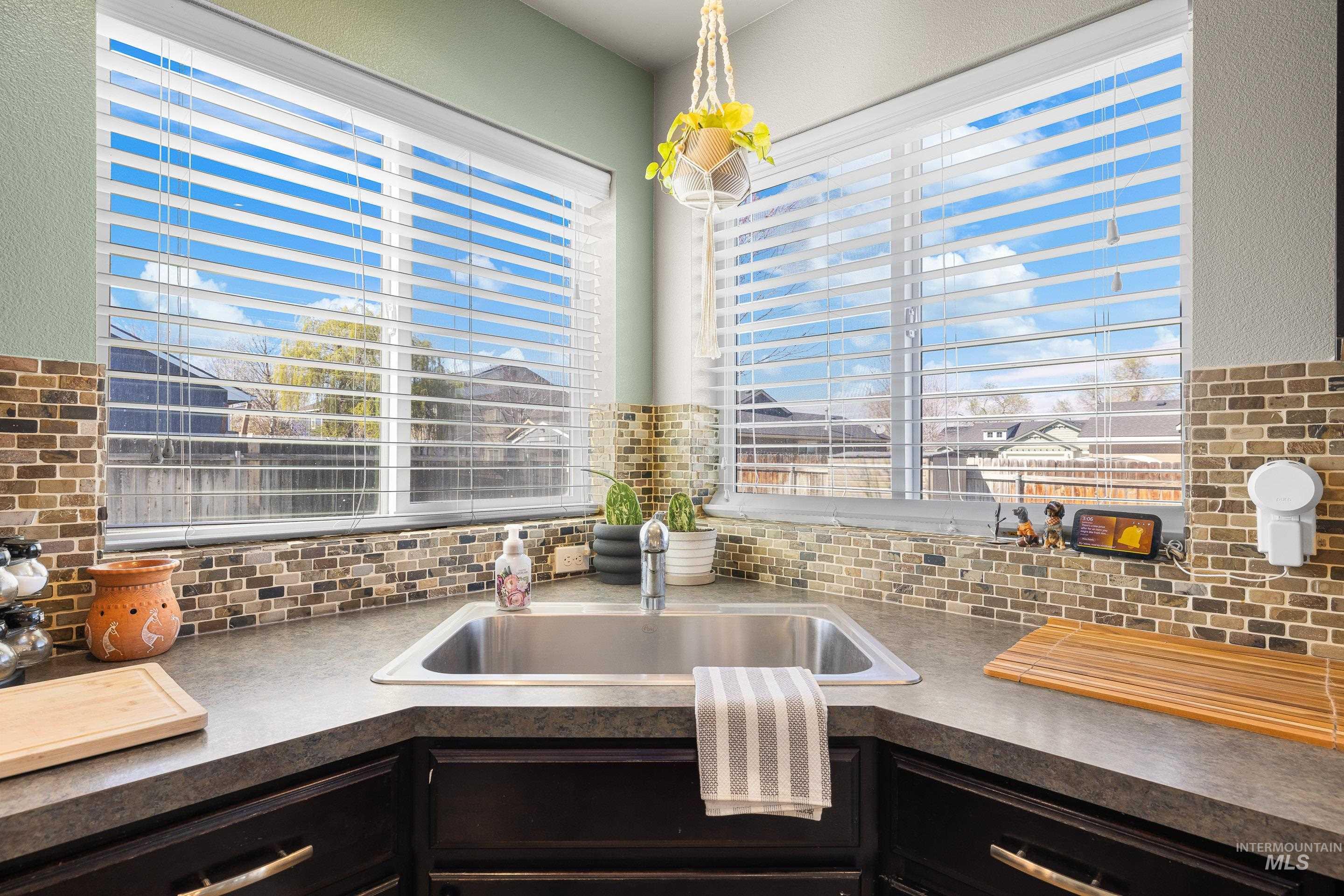 700 Southwest Panner Street Mountain Home, ID 83647 - Photo 17 of 50 Kitchen featuring dark countertops and a sink