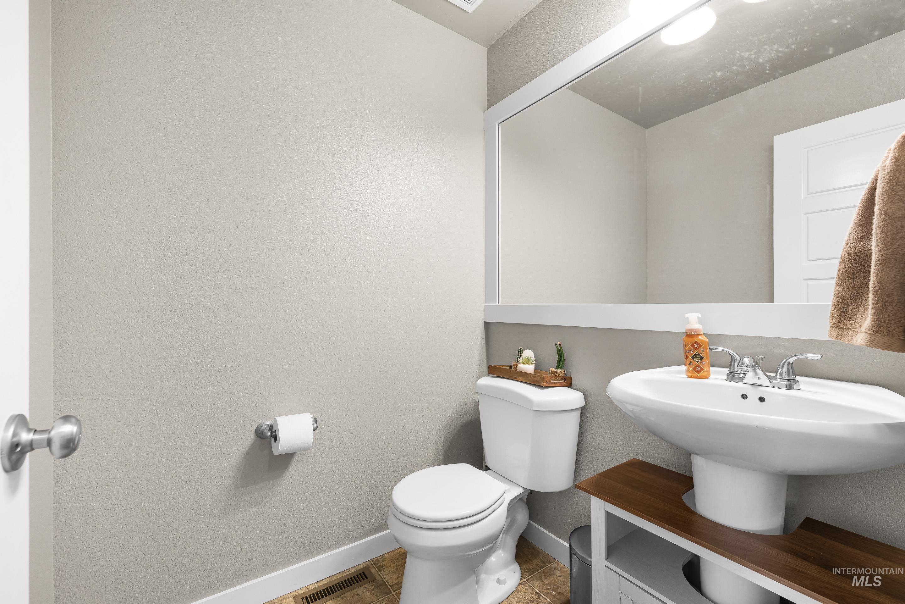 700 Southwest Panner Street Mountain Home, ID 83647 - Photo 21 of 50 Half bathroom featuring toilet and baseboards