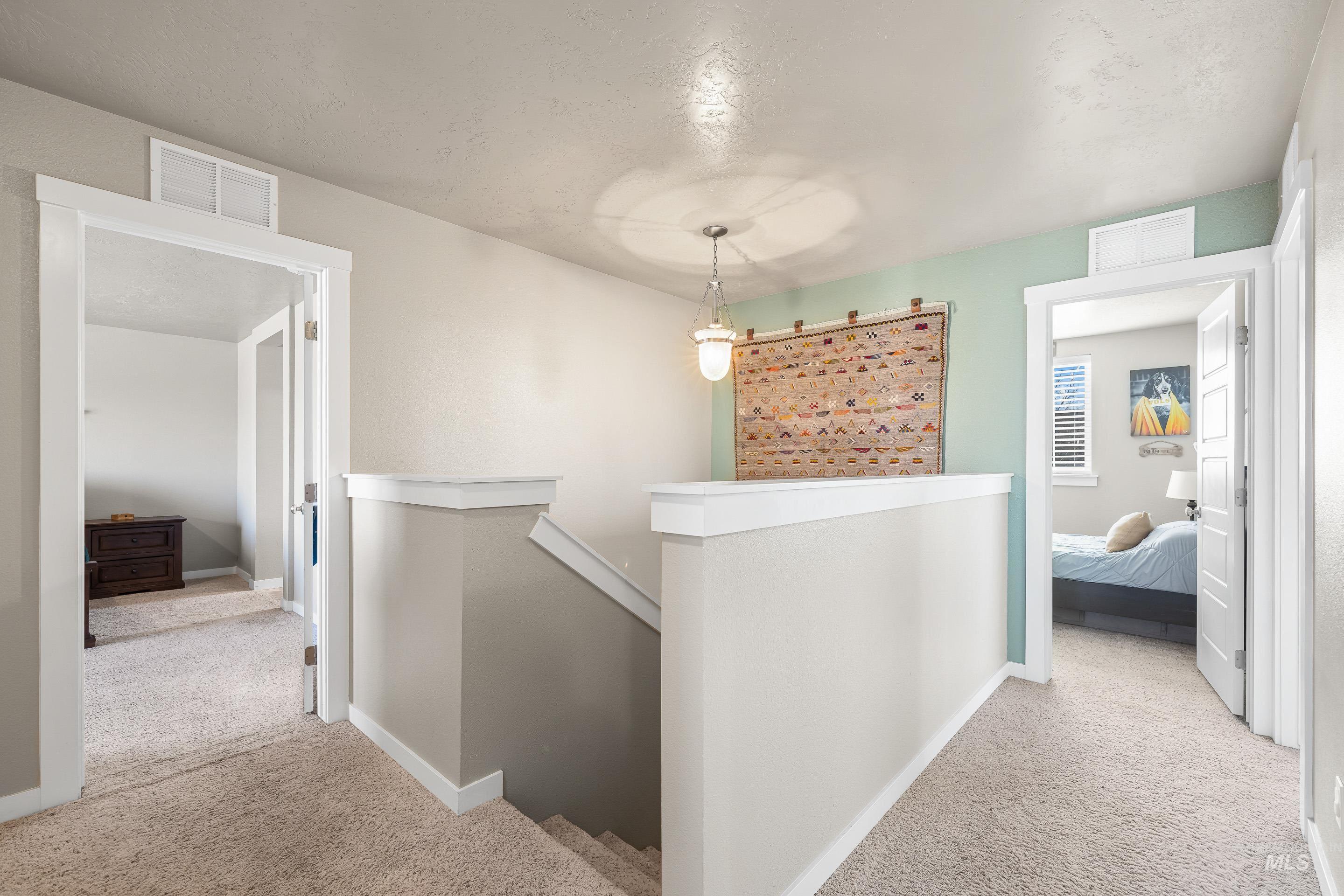 700 Southwest Panner Street Mountain Home, ID 83647 - Photo 24 of 50 Corridor featuring an upstairs landing and light colored carpet