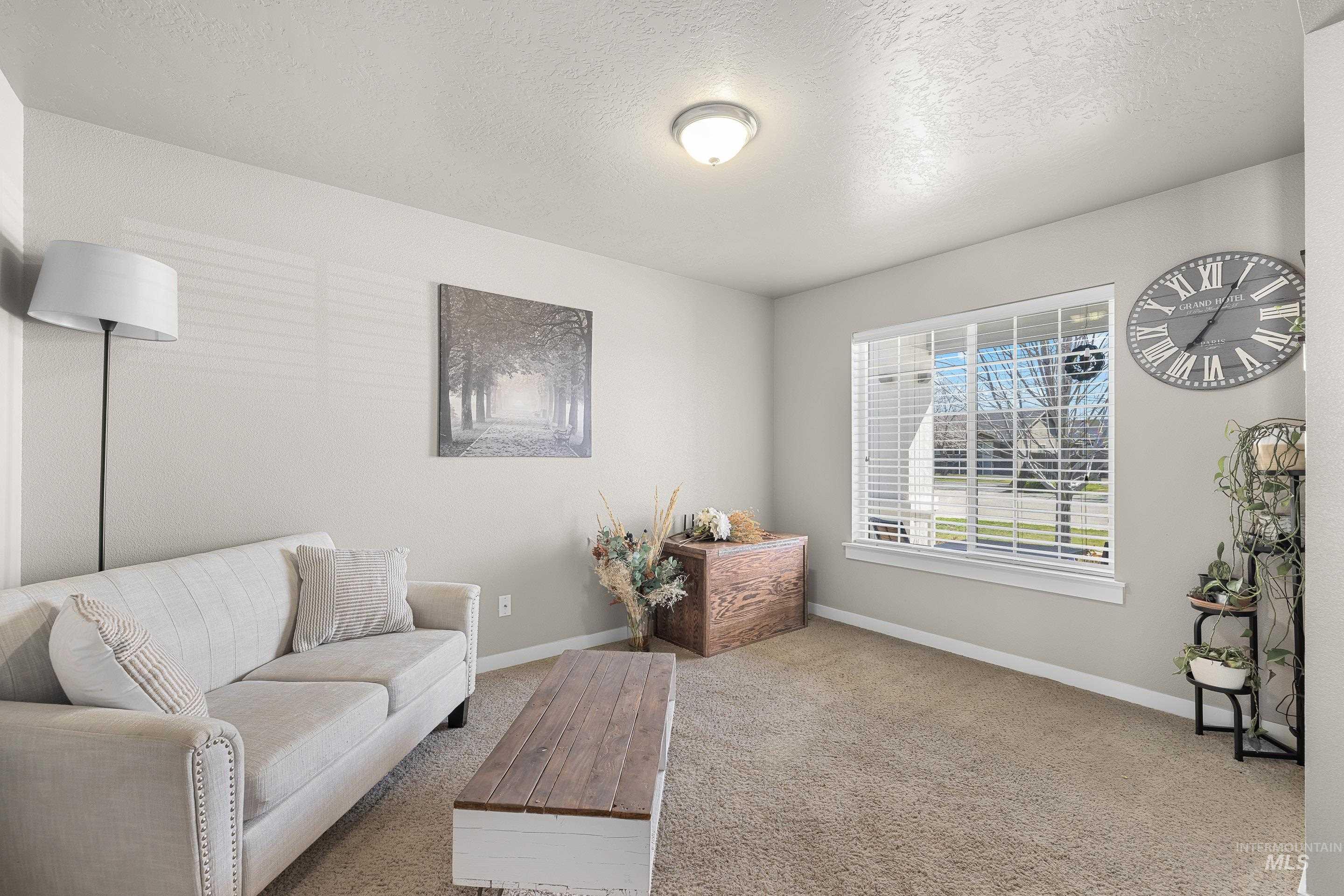 700 Southwest Panner Street Mountain Home, ID 83647 - Photo 25 of 50 Sitting room featuring a textured ceiling and carpet flooring