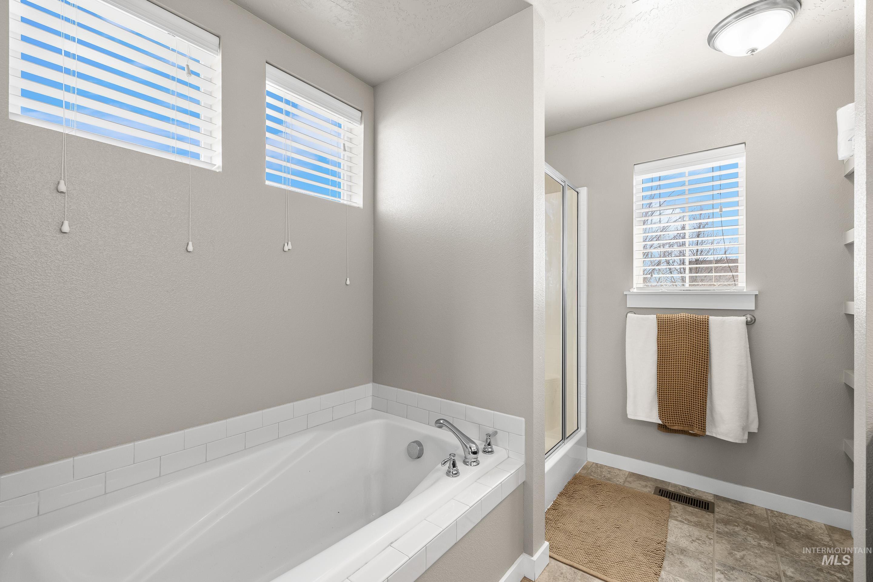 700 Southwest Panner Street Mountain Home, ID 83647 - Photo 32 of 50 Full bath with a shower stall, plenty of natural light, and a bath