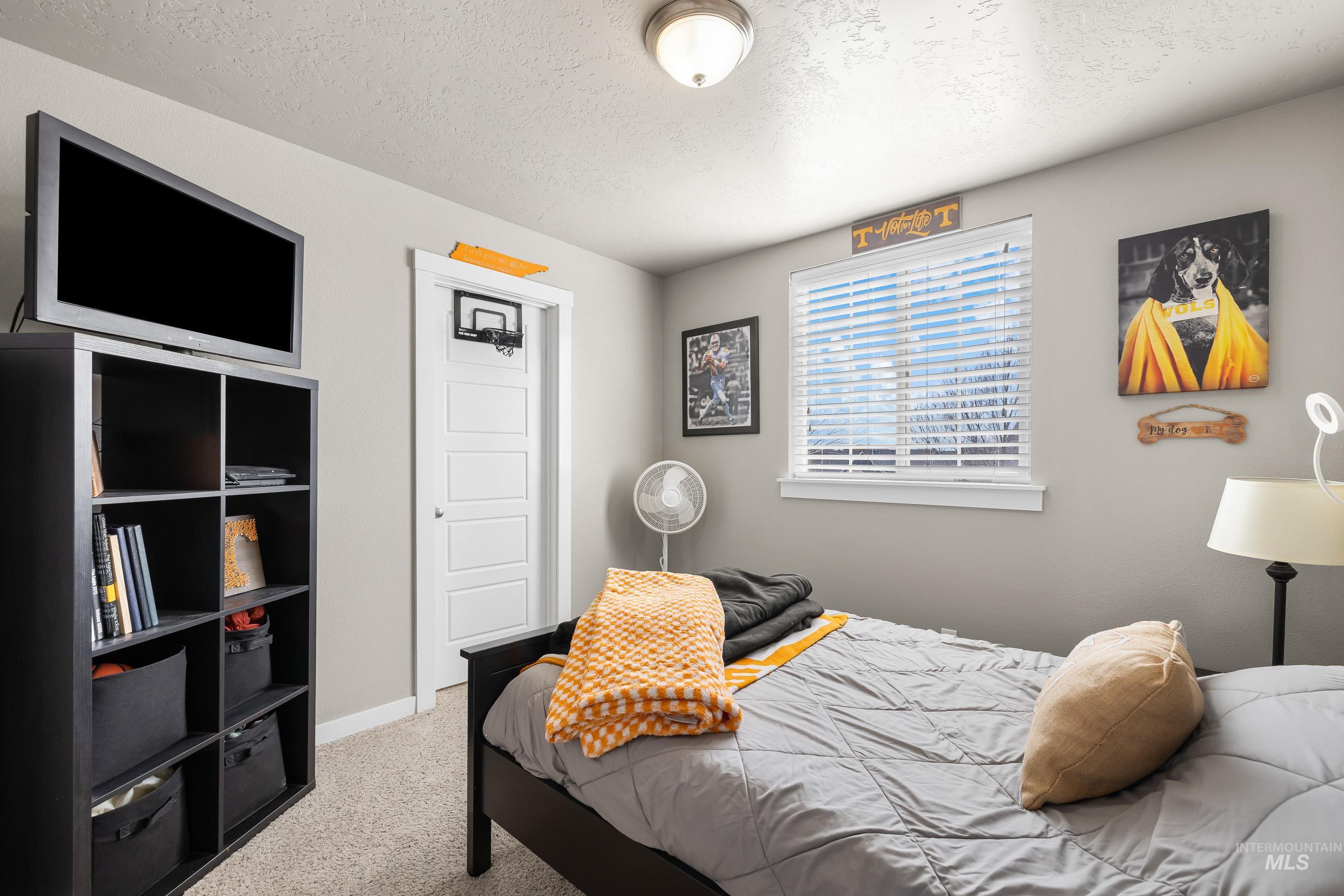 700 Southwest Panner Street Mountain Home, ID 83647 - Photo 38 of 50 Bedroom with light colored carpet and a textured ceiling