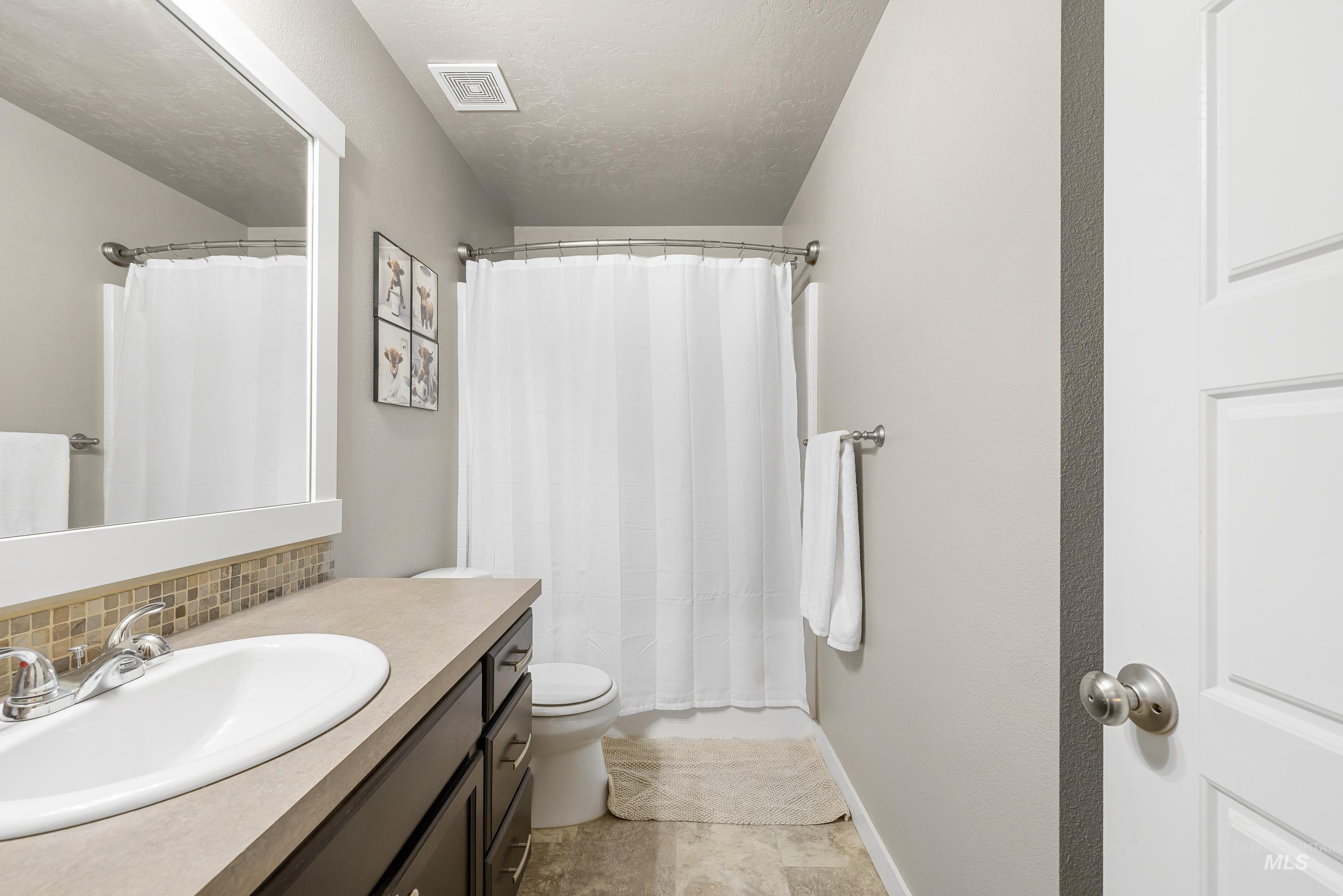 700 Southwest Panner Street Mountain Home, ID 83647 - Photo 40 of 50 Bathroom with vanity and a textured ceiling