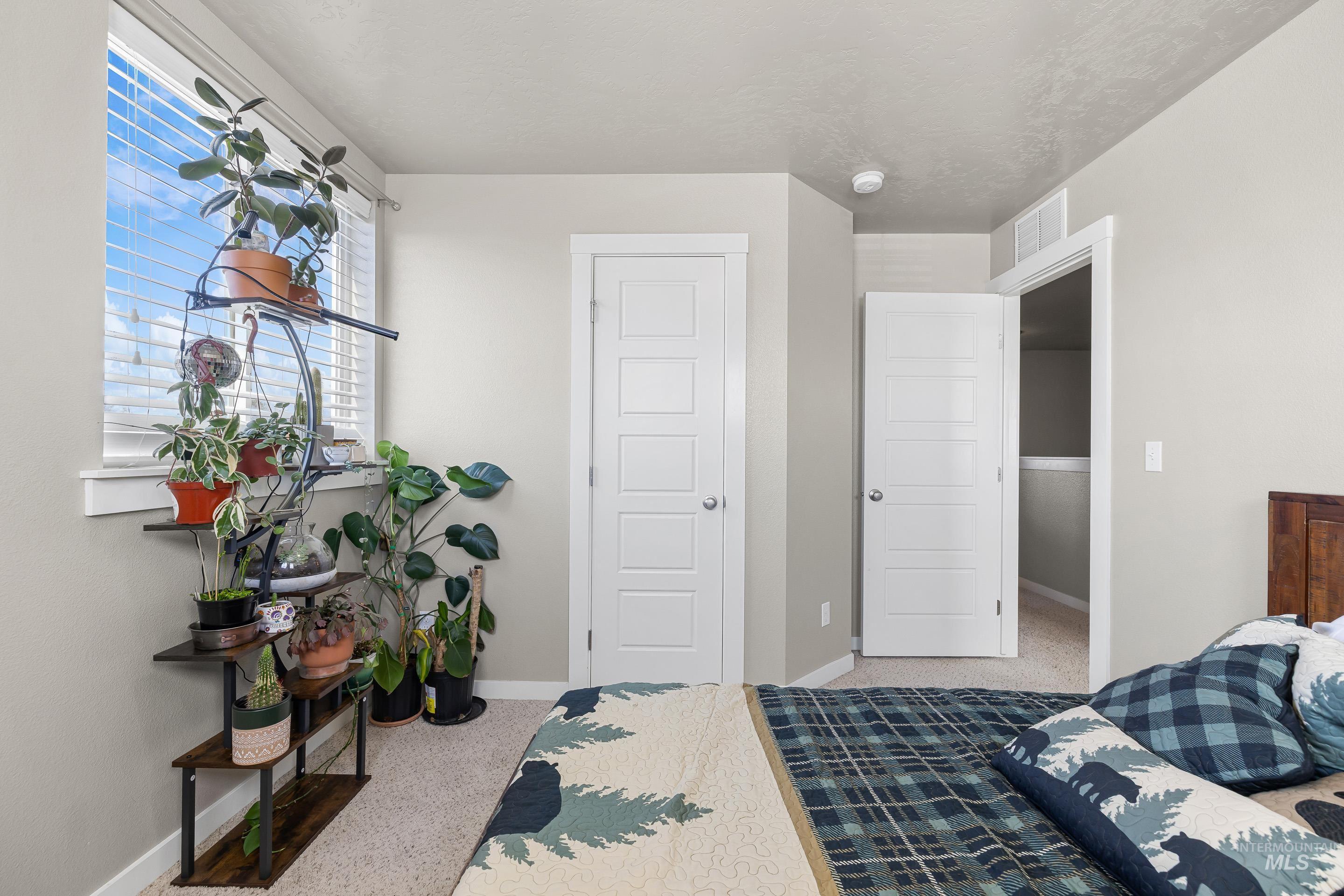 700 Southwest Panner Street Mountain Home, ID 83647 - Photo 41 of 50 Bedroom featuring light carpet and baseboards